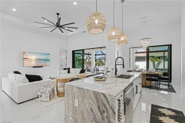 a very nice looking dining room with a large window and chandelier