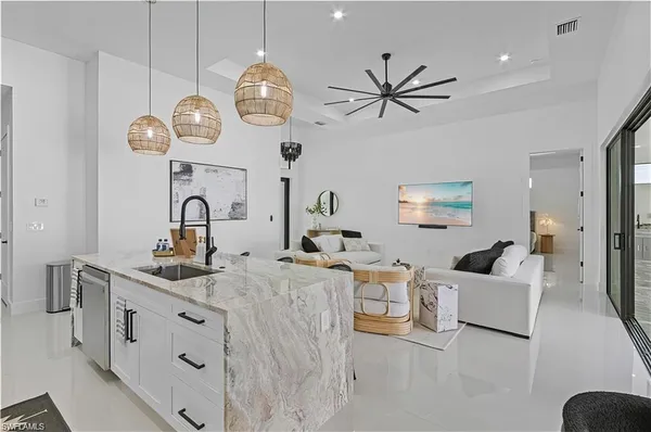 a living room with kitchen island furniture and kitchen view