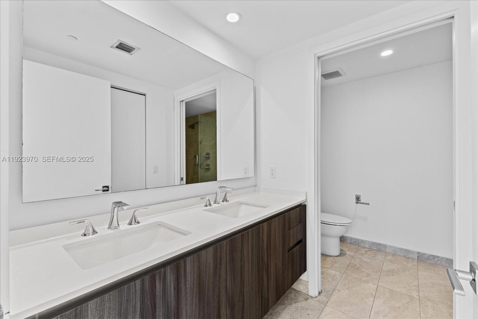 488 Northeast 18th Street, Unit 4102 Miami, FL 33132 - Photo 18 of 60 a bathroom with a double vanity sink and a mirror