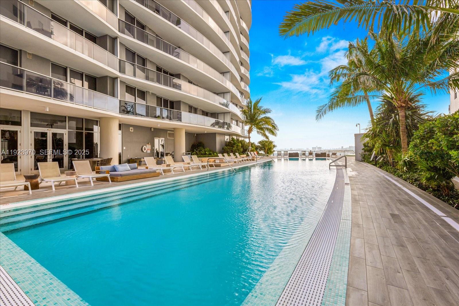 488 Northeast 18th Street, Unit 4102 Miami, FL 33132 - Photo 33 of 60 a view of swimming pool with outdoor seating and lake view