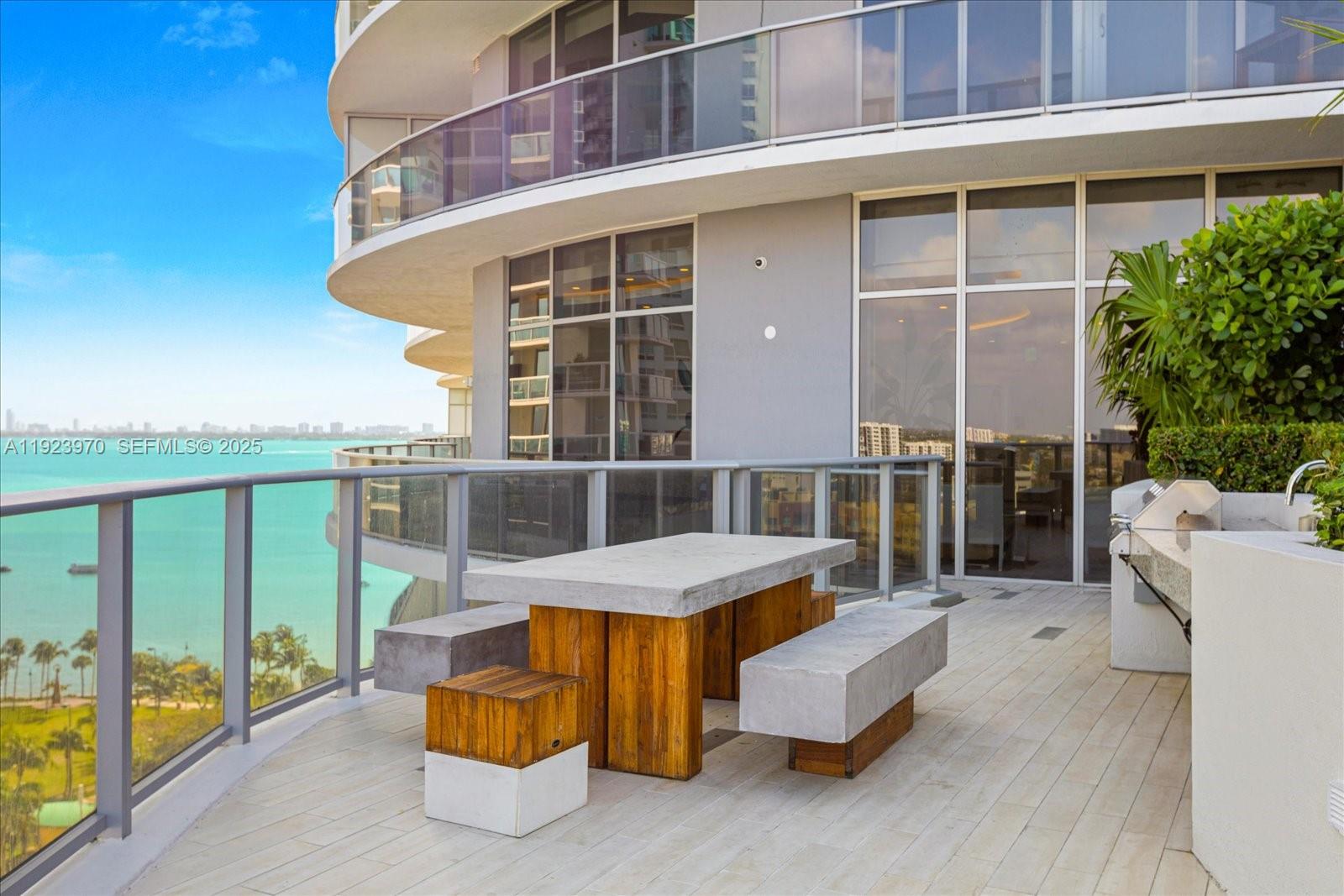 488 Northeast 18th Street, Unit 4102 Miami, FL 33132 - Photo 38 of 60 a view of a patio with couches table and chairs and potted plants