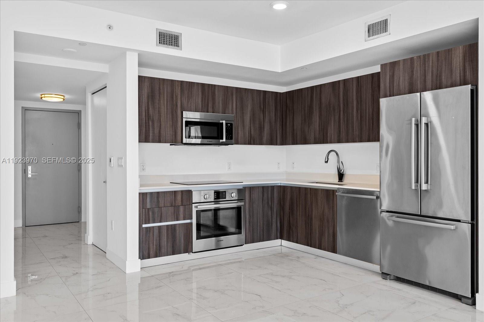 488 Northeast 18th Street, Unit 4102 Miami, FL 33132 - Photo 9 of 60 a kitchen with a refrigerator sink and microwave