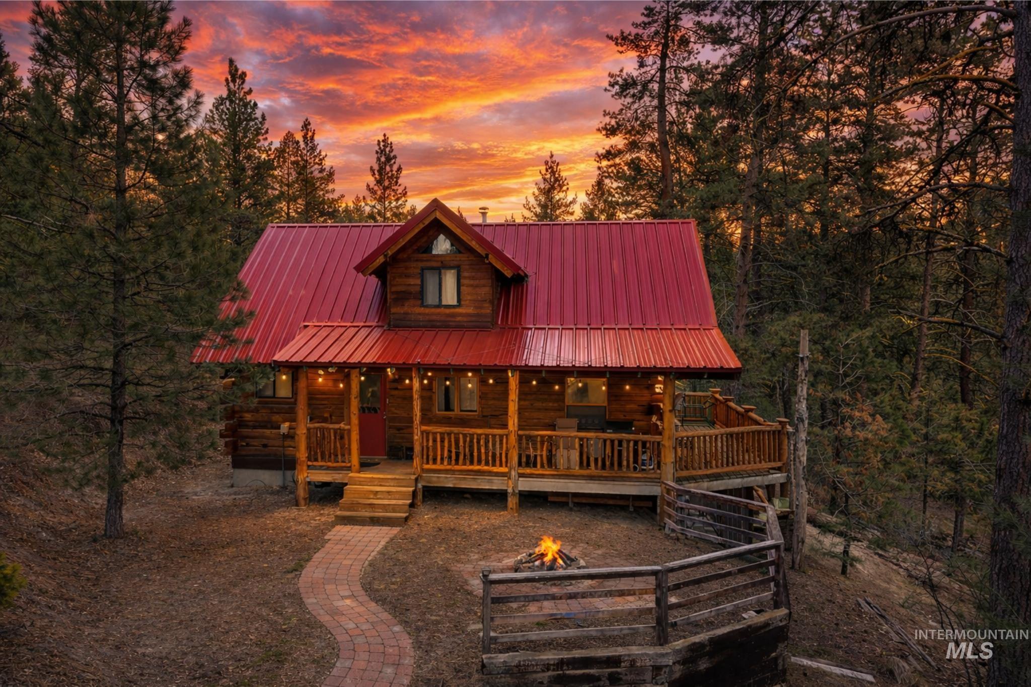 397 Warm Lake Road Cascade, ID 83611 - Photo 2 of 30 View of front of house with covered porch, log siding, and a metal roof