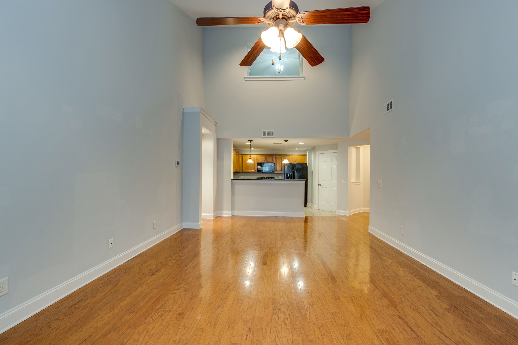 3201 Aspen Grove Drive, Unit F9 Franklin, TN 37067 - Photo 16 of 33 an empty room with wooden floor chandelier fan and windows