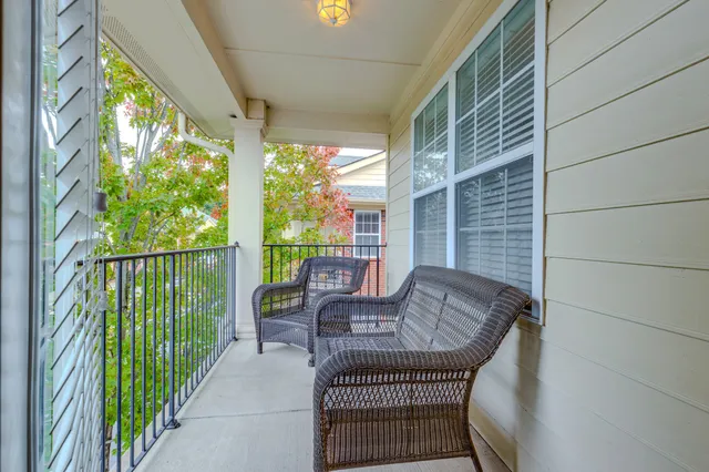 a balcony view with a couches and dining table with wooden floor