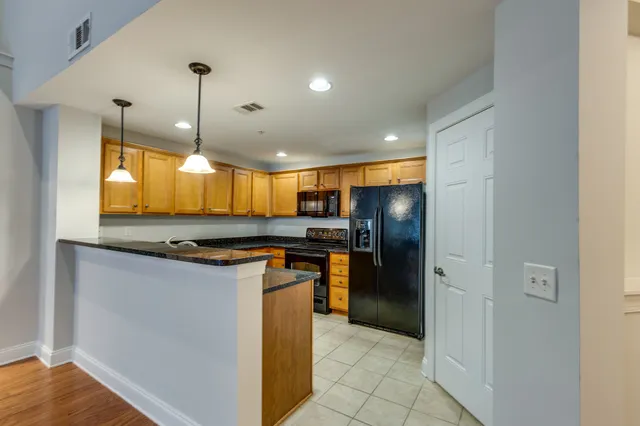 a kitchen with stainless steel appliances granite countertop a refrigerator and a sink