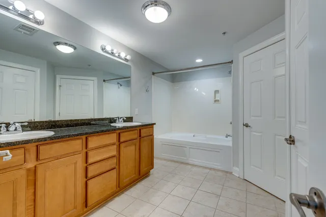 a bathroom with a tub a sink and a shower