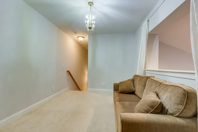 a living room with furniture and a ceiling fan