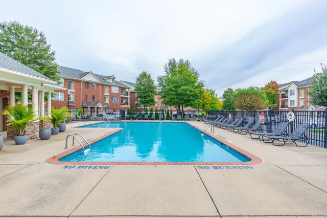 a view of swimming pool with outdoor seating and plants