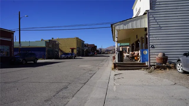 a living room with furniture a flat screen tv and gym equipment