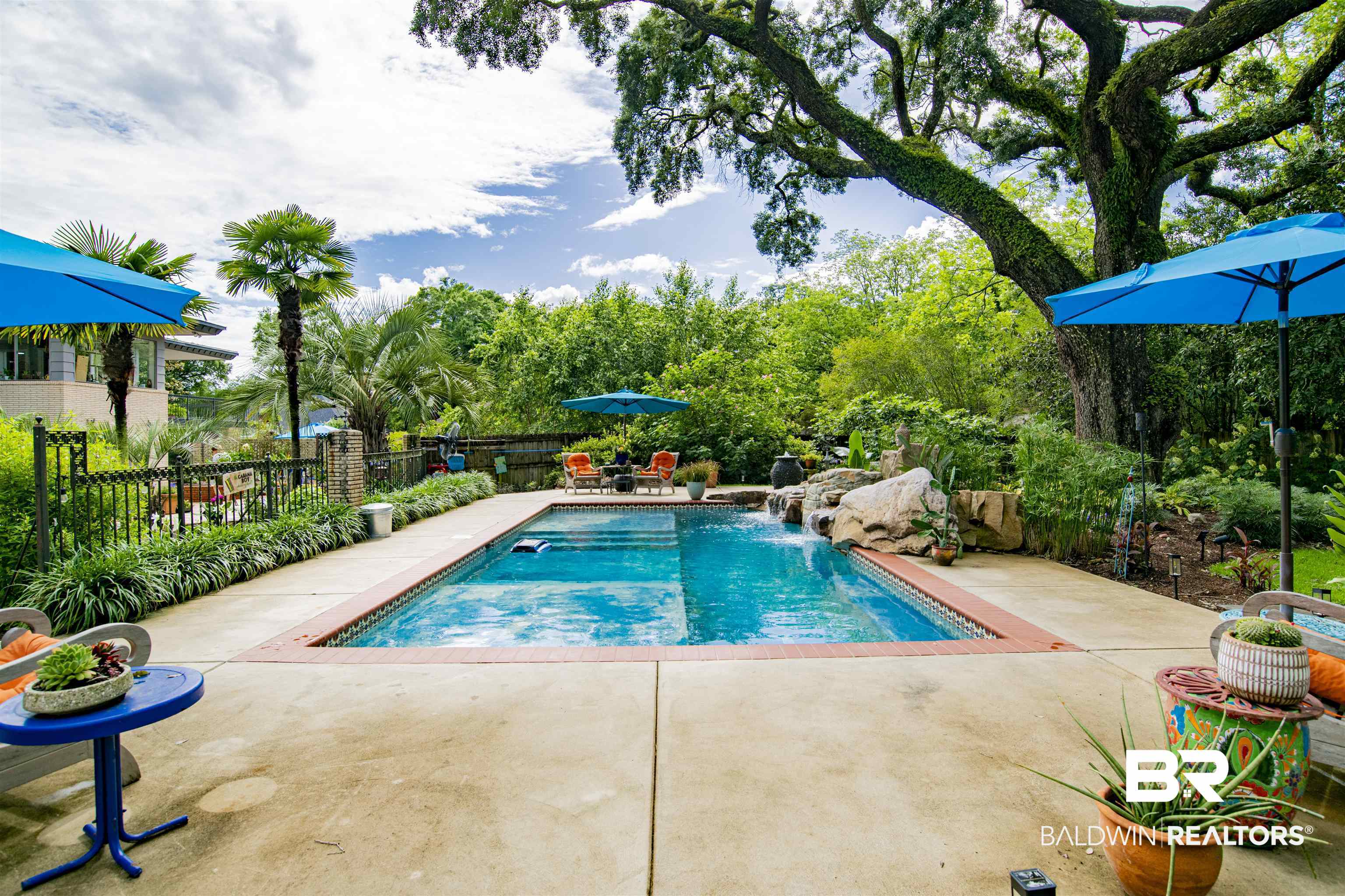 809 Bernard Circle Mobile, AL 36693 - Photo 63 of 75 In-ground swimming pool featuring a waterfall rock formation and tiled edging