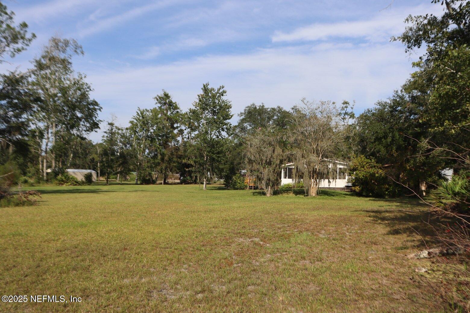 10004 Allene Road Jacksonville, FL 32219 - Photo 3 of 8 a view of a field with trees in the background