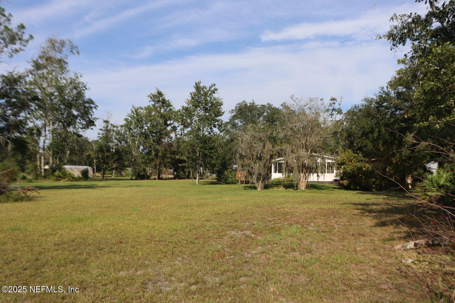 10004 Allene Road Jacksonville, FL 32219 - Photo 4 of 8 a view of a field with trees in the background
