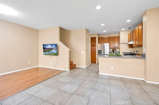 a view of kitchen with kitchen island white cabinets and stainless steel appliances