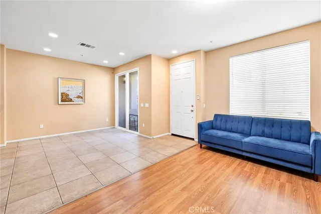 a living room with couch and a large window