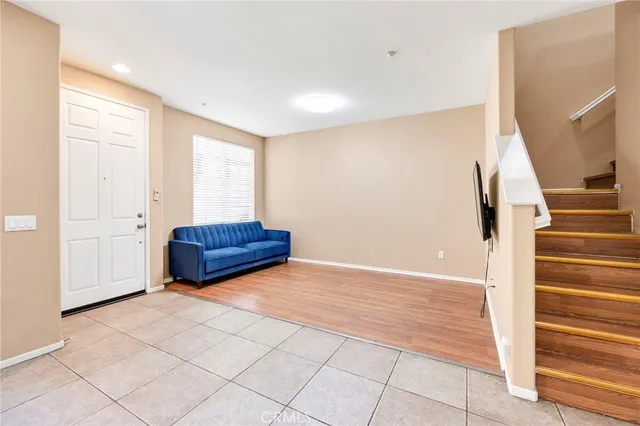 a view of front door with wooden floor and stairs