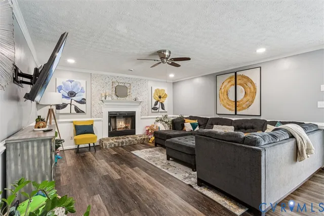 a living room with furniture a fireplace and a flat screen tv