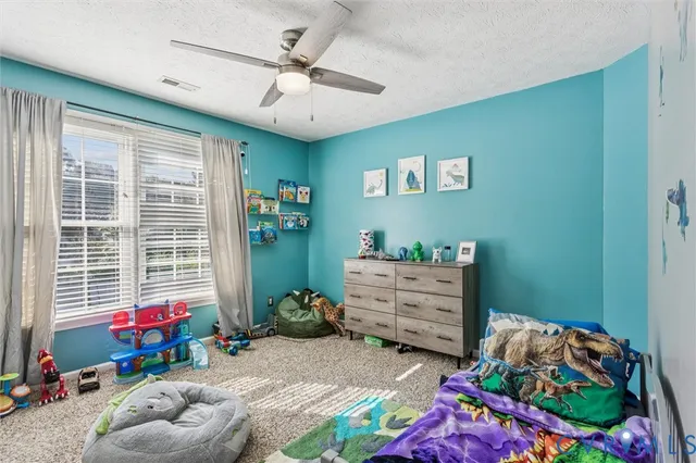 a bedroom with furniture and a baby crib