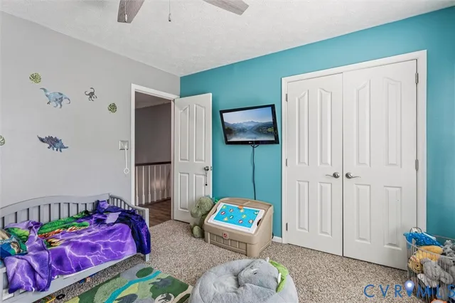 a bedroom with a bed and dresser with mirror