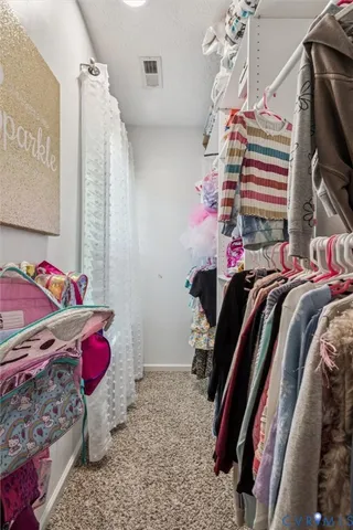 a bedroom with a bed and a dresser in it