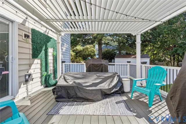 a view of a patio with a table chairs and a backyard