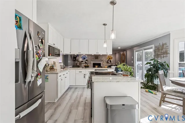 a kitchen with a sink stainless steel appliances and white cabinets