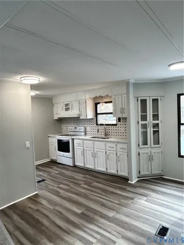 a kitchen with stainless steel appliances granite countertop a stove and cabinets