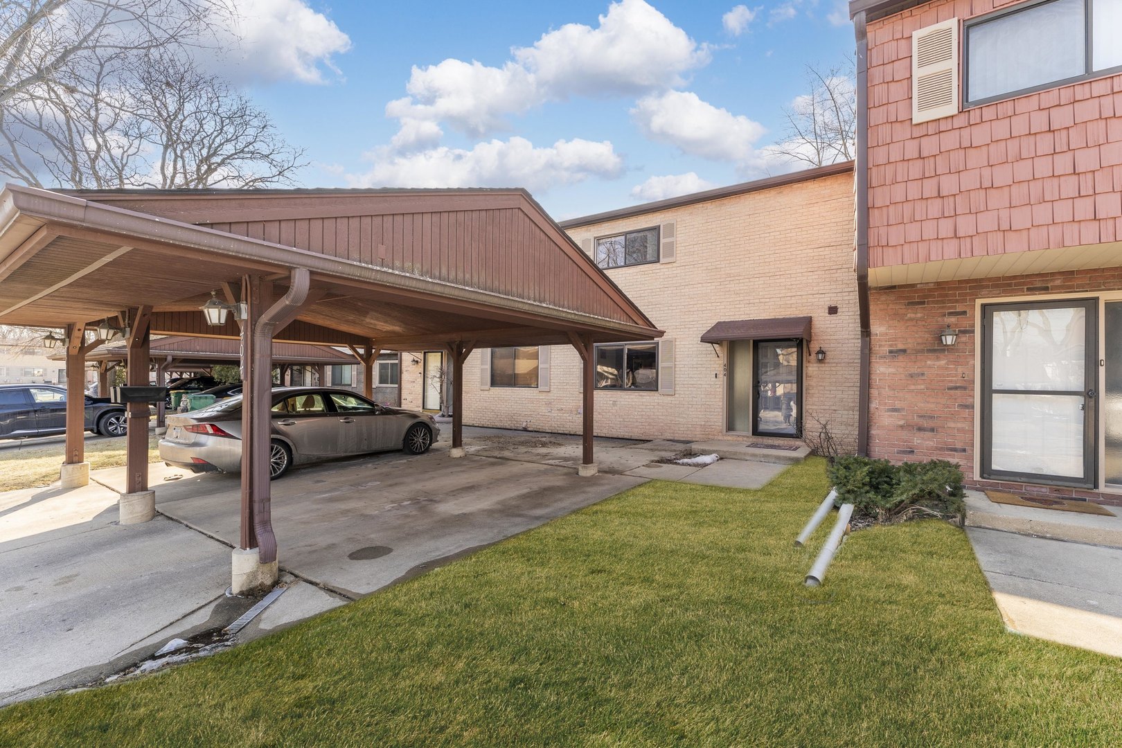 a view of a house with backyard and sitting area