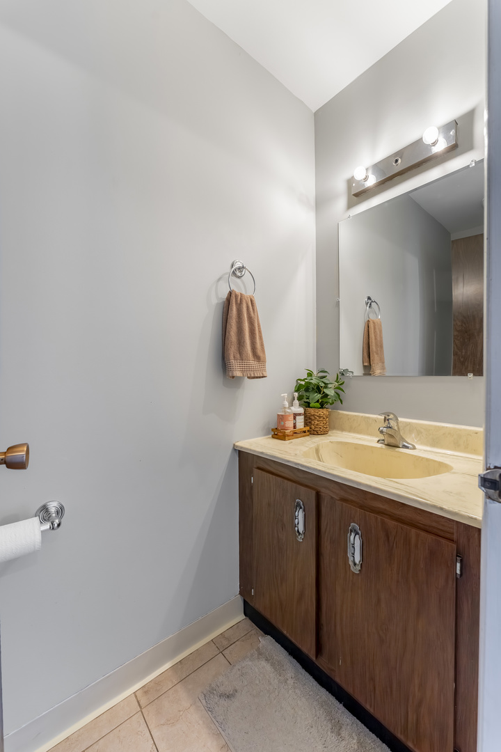 404 Arrow Trail Wheeling, IL 60090 - Photo 7 of 26 a bathroom with a double vanity sink and a mirror