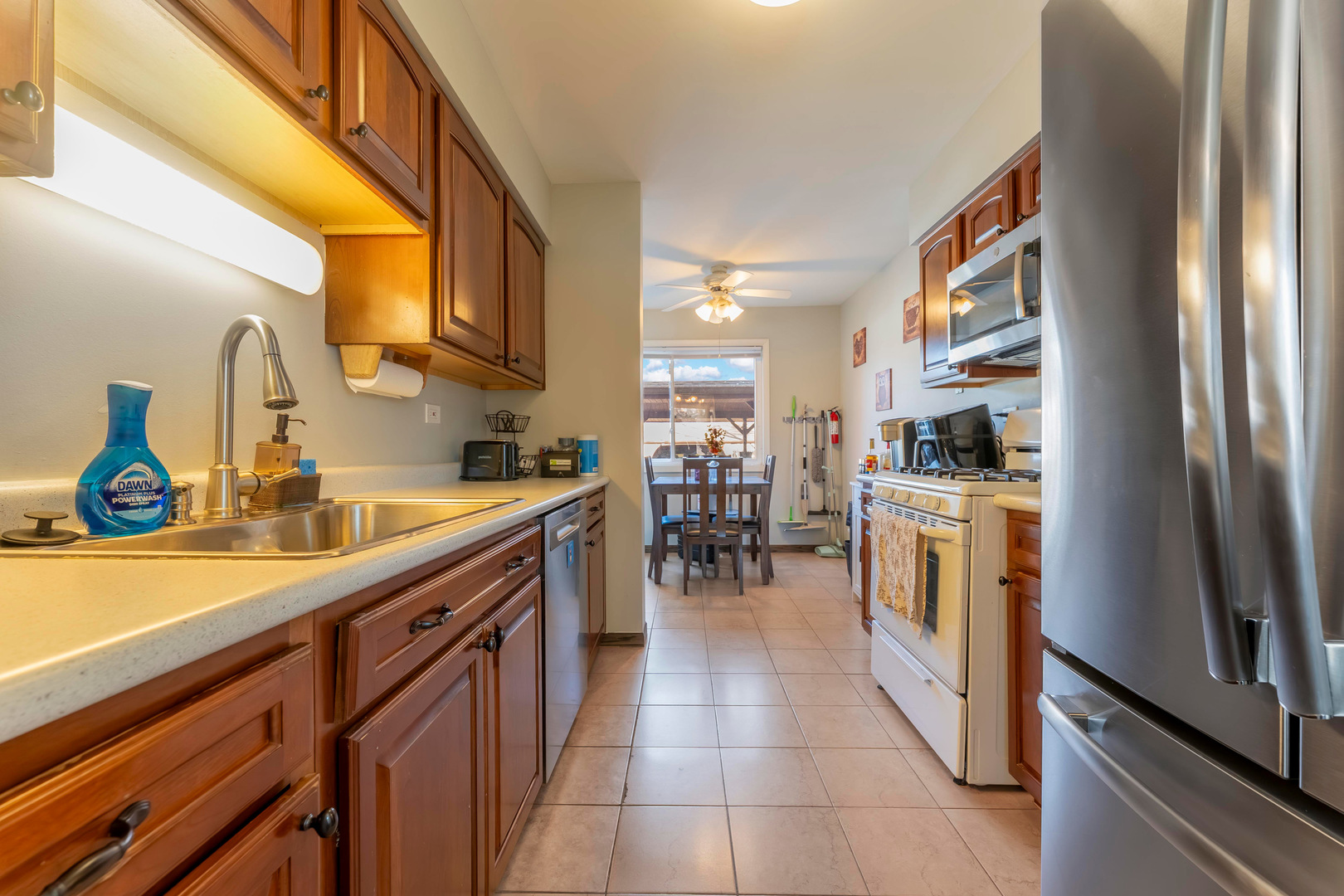 404 Arrow Trail Wheeling, IL 60090 - Photo 10 of 26 a kitchen with stainless steel appliances a sink a stove and a refrigerator