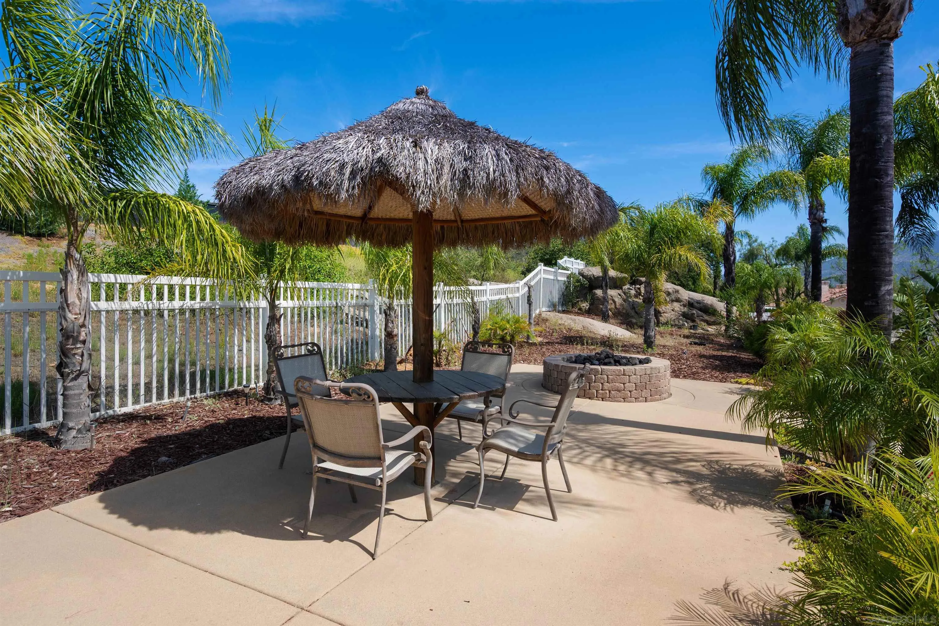 2882 Conestoga Circle Alpine, CA 91901 - Photo 60 of 75 a view of a patio with a table and chairs under an umbrella with a garden