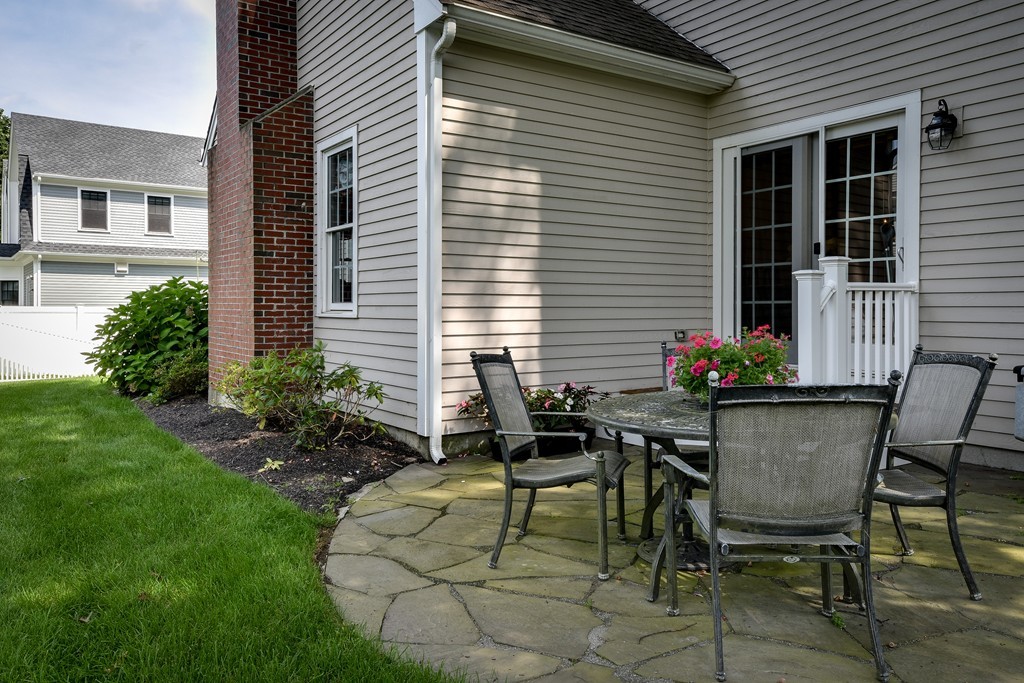 11 Marshall Road Wellesley, MA 02482 - Photo 16 of 18 a table and chairs in front of a house