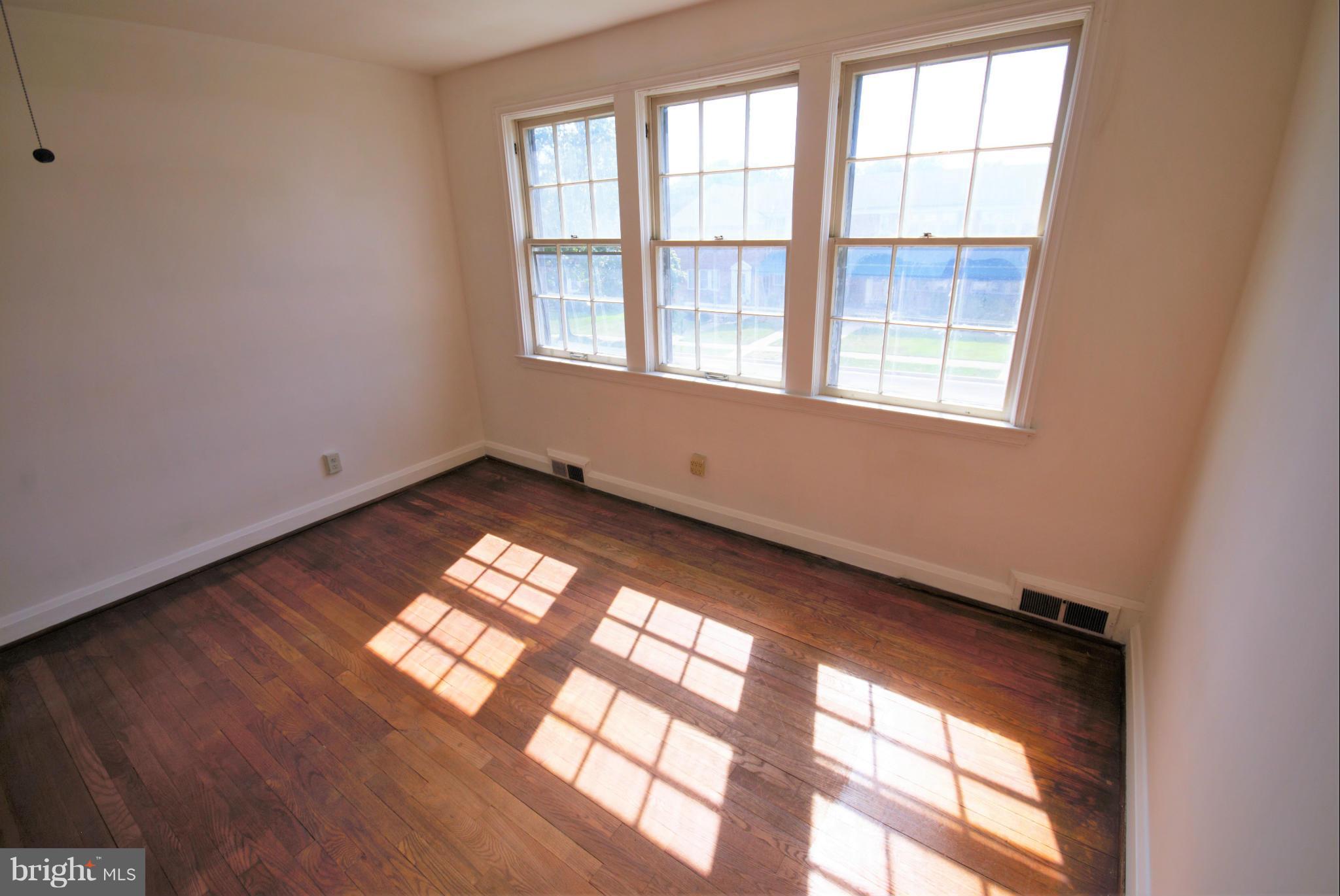 1854 Loch Shiel Road Baltimore, MD 21286 - Photo 14 of 23 an empty room with wooden floor and windows