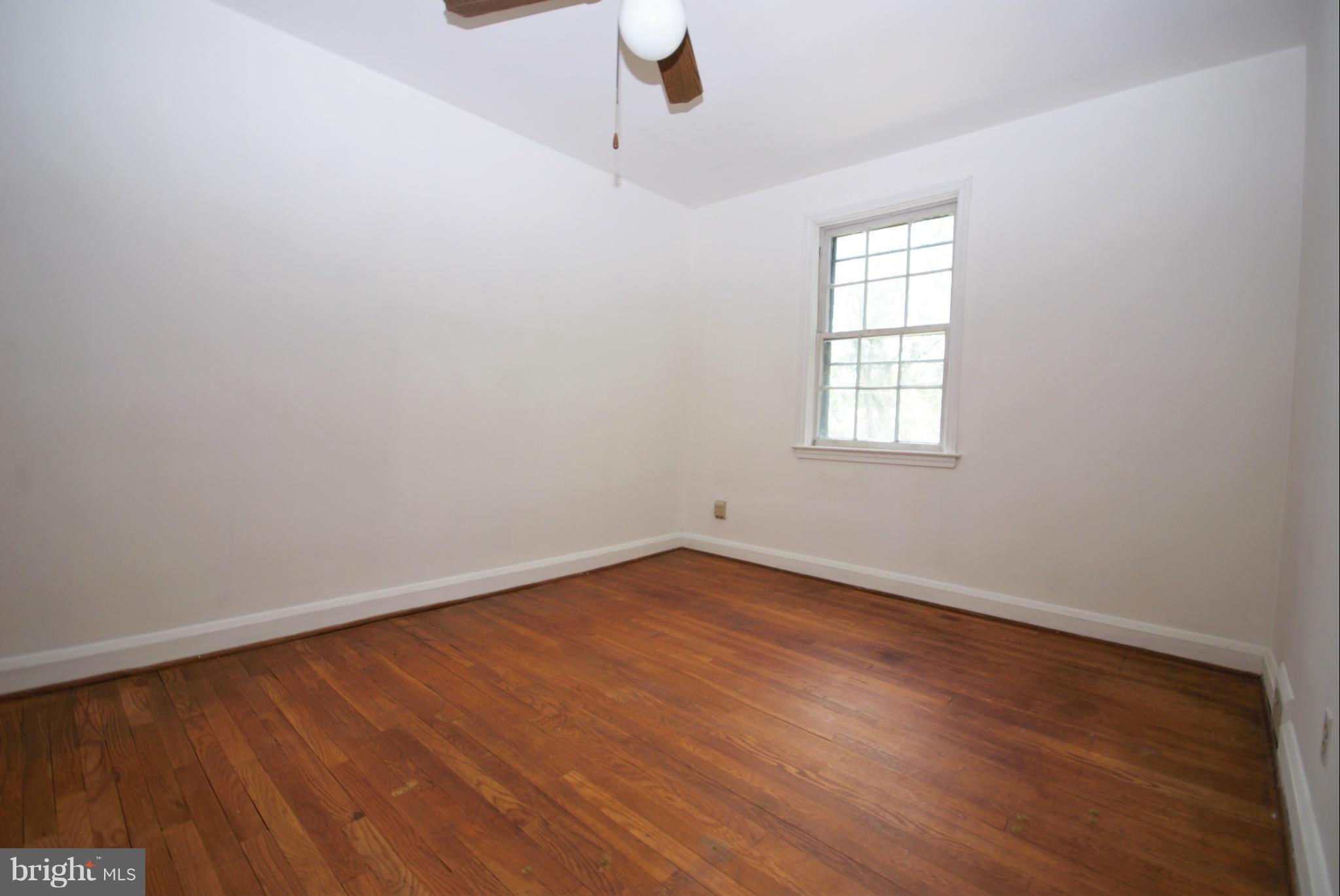 1854 Loch Shiel Road Baltimore, MD 21286 - Photo 17 of 23 an empty room with wooden floor cabinet and windows