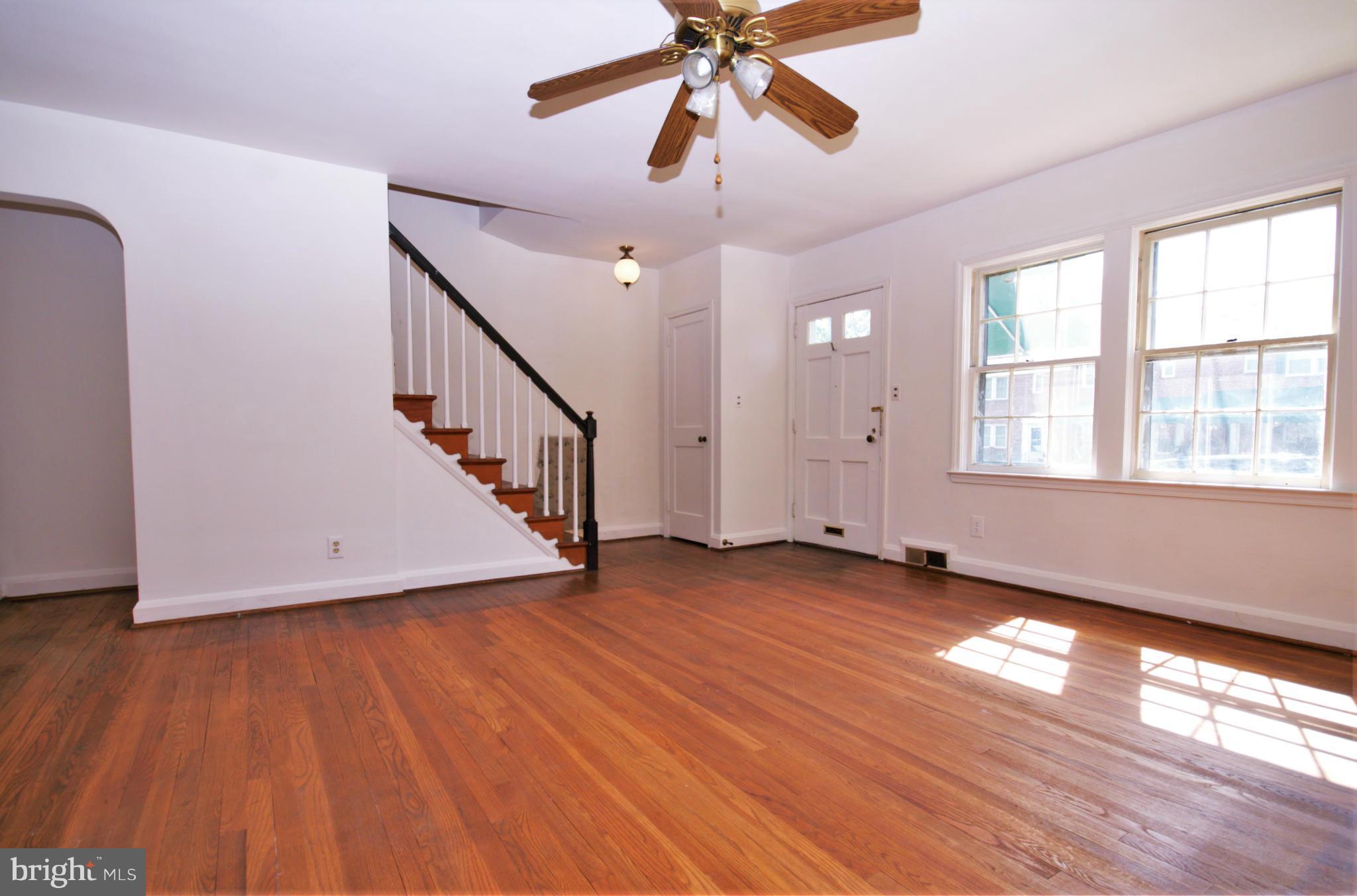 1854 Loch Shiel Road Baltimore, MD 21286 - Photo 5 of 23 a view of an empty room with wooden floor and a window