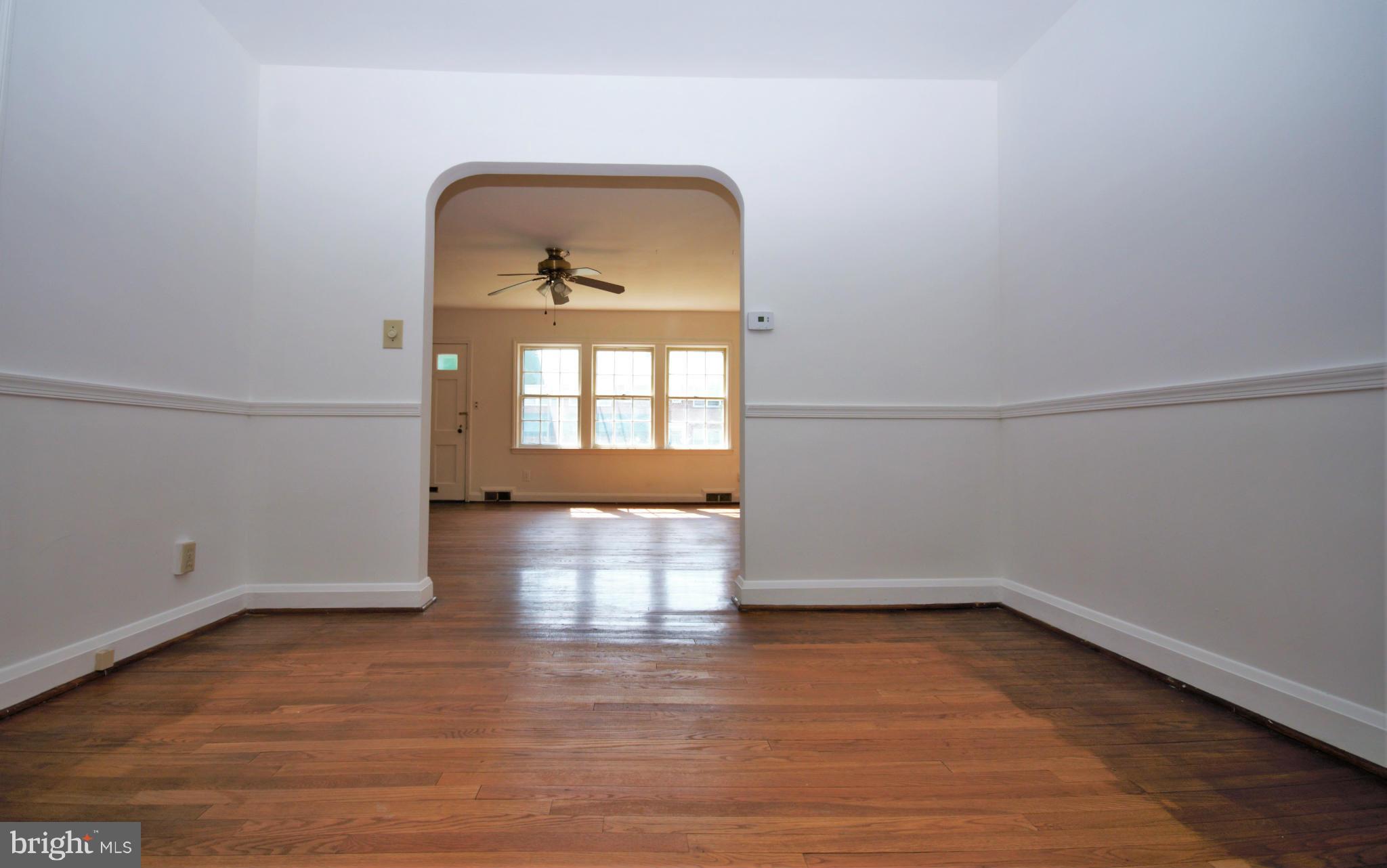 1854 Loch Shiel Road Baltimore, MD 21286 - Photo 7 of 23 an empty room with wooden floor and windows