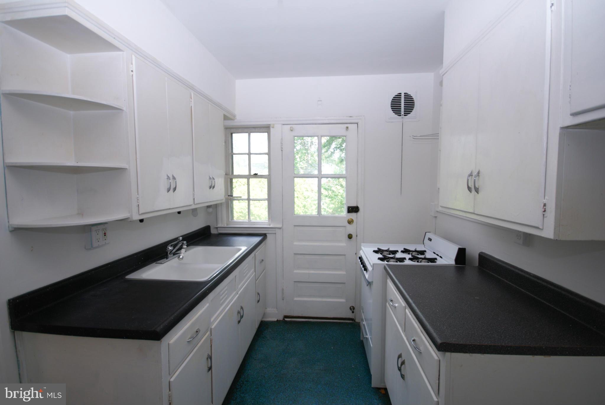 1854 Loch Shiel Road Baltimore, MD 21286 - Photo 8 of 23 a kitchen with a sink stove and cabinets