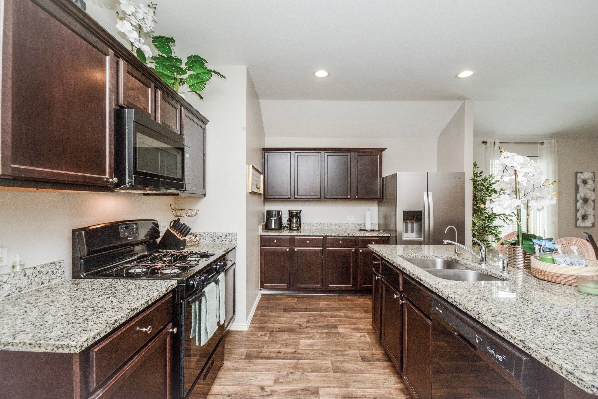 23510 Harrow Fld Lane Spring, TX 77373 - Photo 4 of 18 a kitchen with stainless steel appliances granite countertop a sink stove and microwave