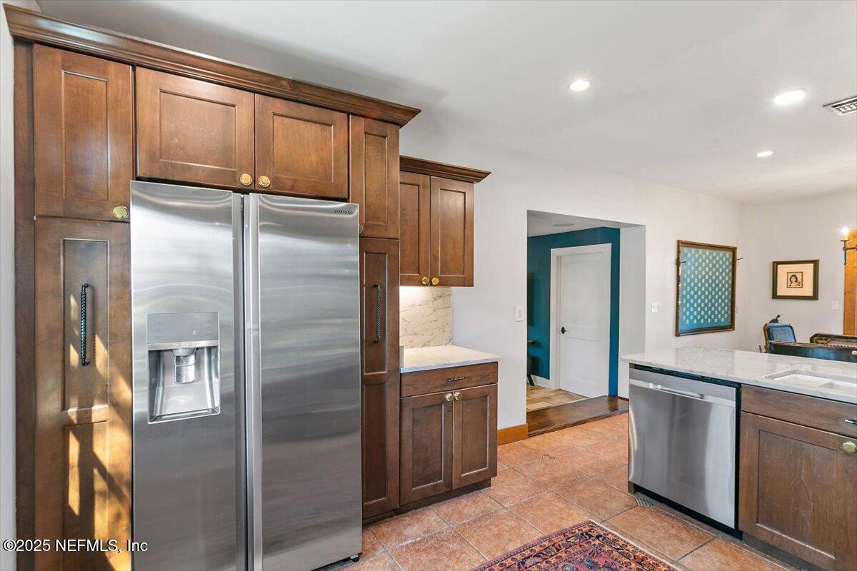 701 Old Hickory Road Jacksonville, FL 32207 - Photo 12 of 36 a kitchen with stainless steel appliances granite countertop a refrigerator and a sink