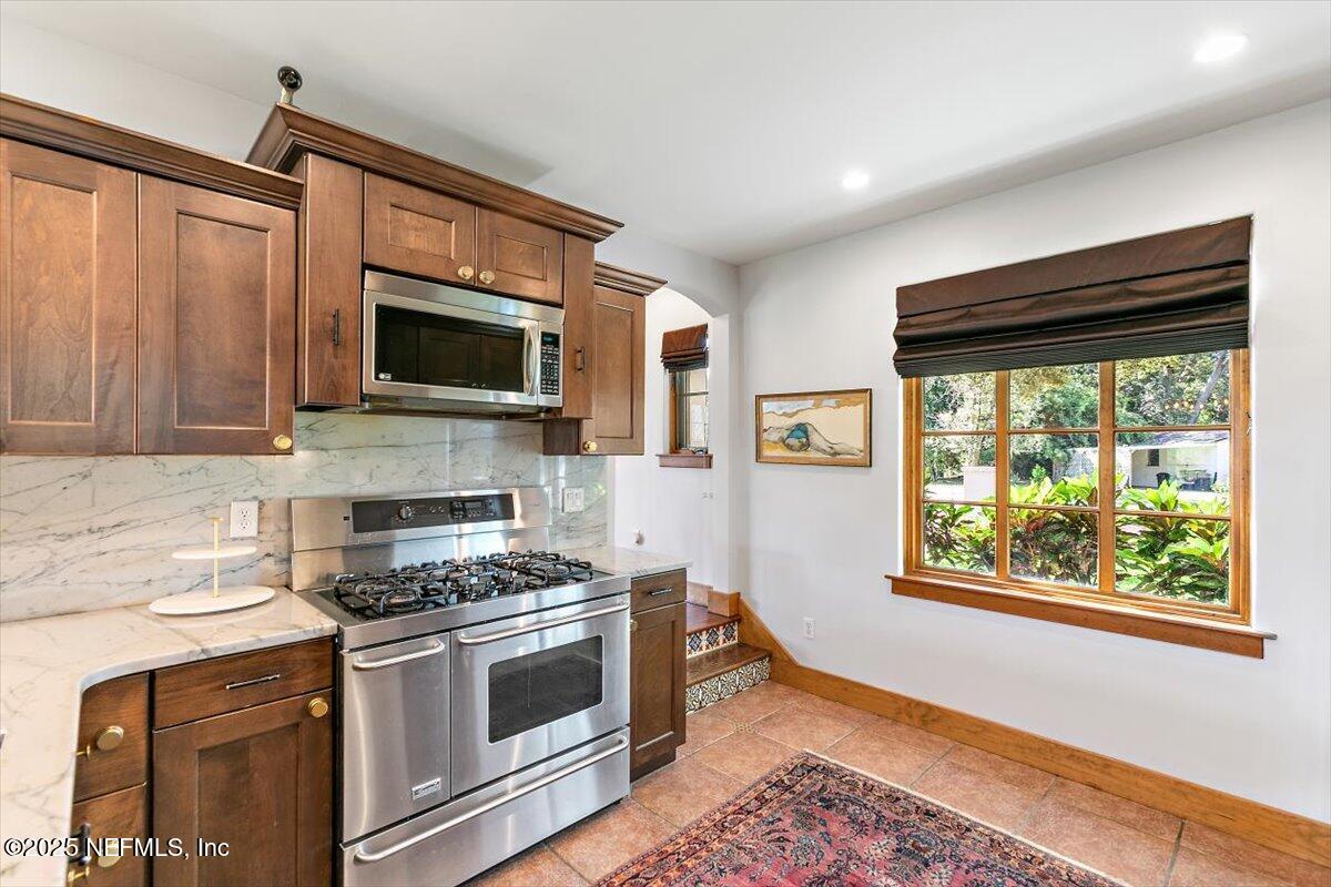 701 Old Hickory Road Jacksonville, FL 32207 - Photo 13 of 36 a kitchen with stainless steel appliances granite countertop a stove top oven a sink and a microwave