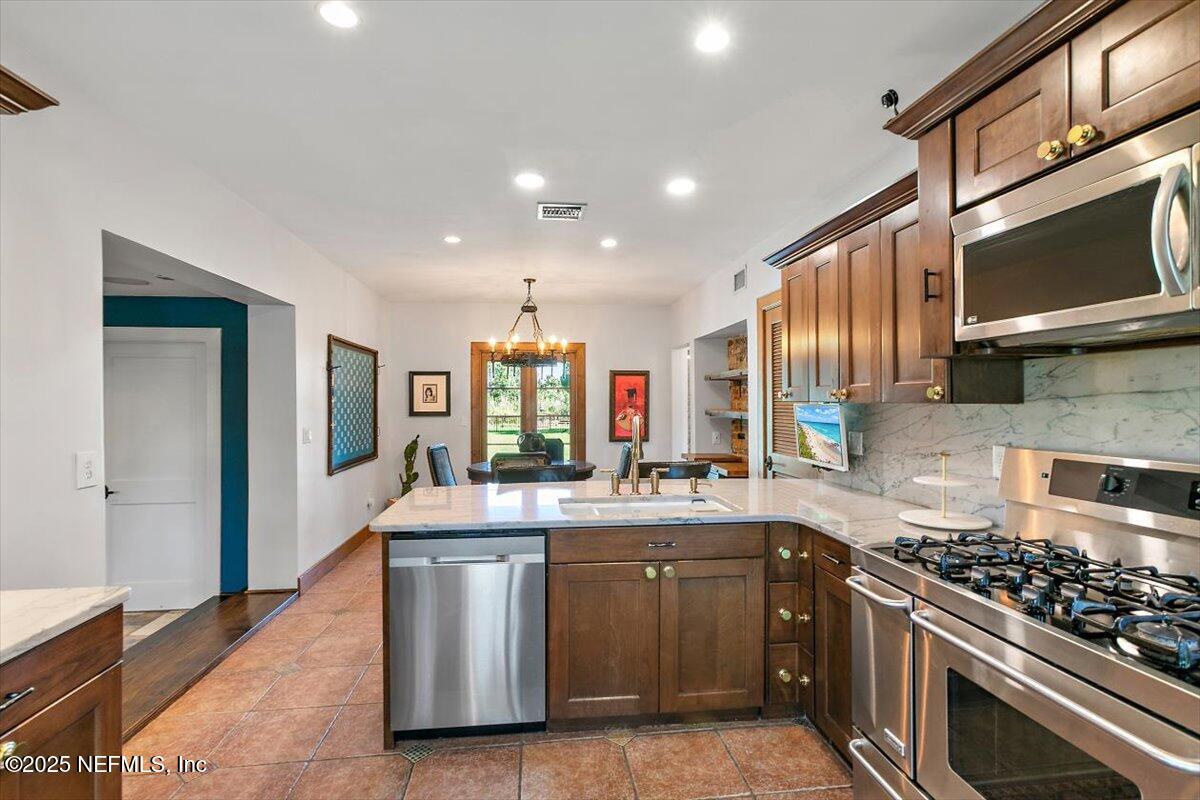 701 Old Hickory Road Jacksonville, FL 32207 - Photo 14 of 36 a kitchen with stainless steel appliances granite countertop a sink stove and refrigerator