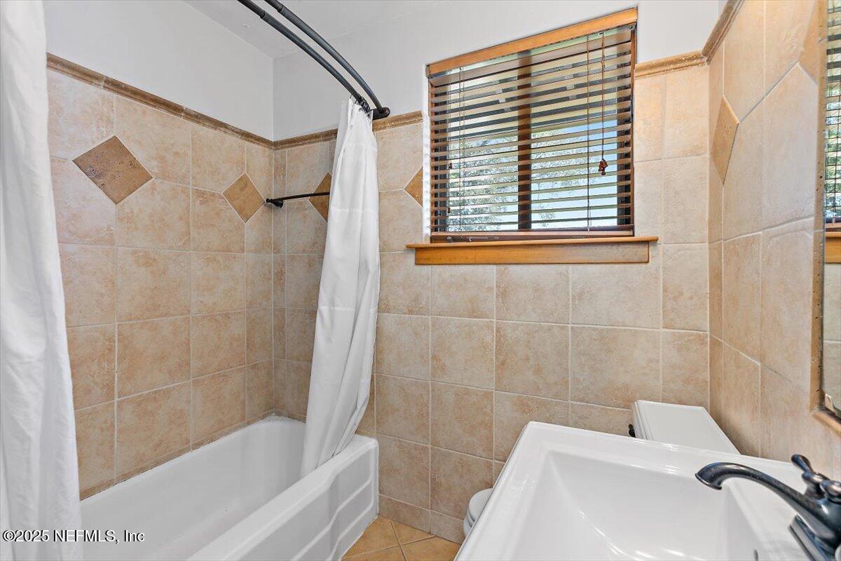 701 Old Hickory Road Jacksonville, FL 32207 - Photo 25 of 36 a bathroom with a bathtub and a shower