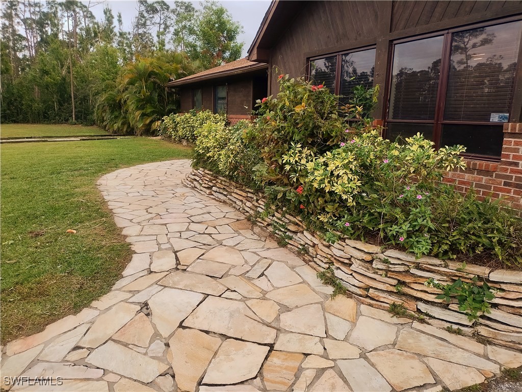 17091 Charlee Road Punta Gorda, FL 33955 - Photo 5 of 44 a view of a backyard with plants and large trees
