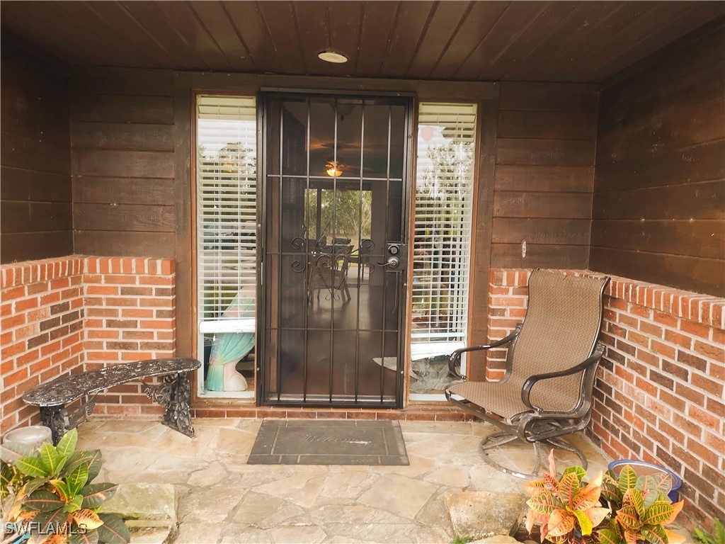17091 Charlee Road Punta Gorda, FL 33955 - Photo 7 of 44 a view of a porch with chairs and a gate