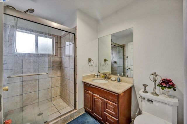 a bathroom with a sink mirror and toilet