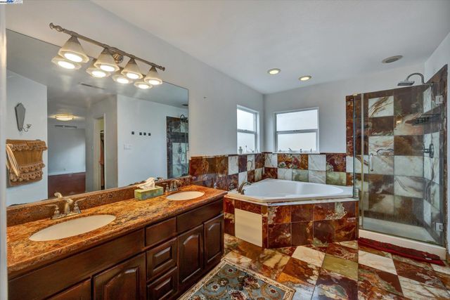 a bath room with sink and mirror
