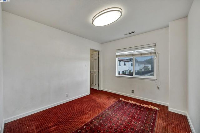 a view of a room with wooden floor and window