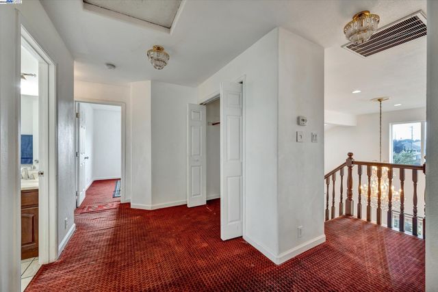 a view of hallway with wooden floor