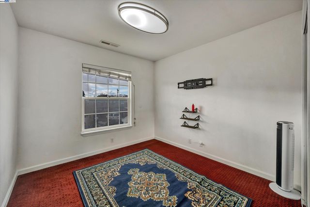 a room with window and a rug