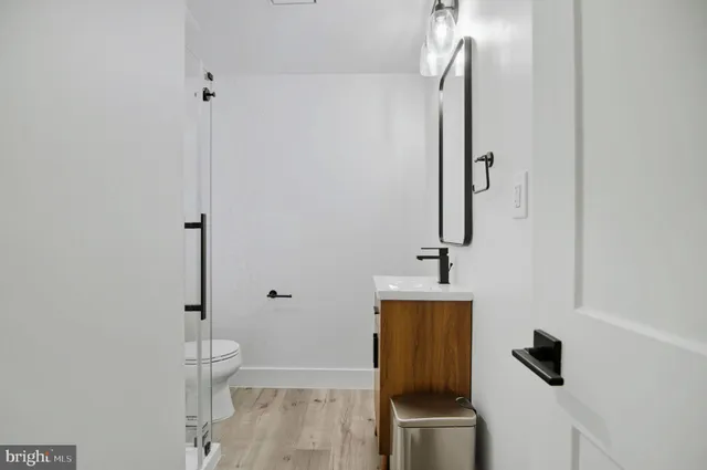 a bathroom with a toilet a sink and mirror